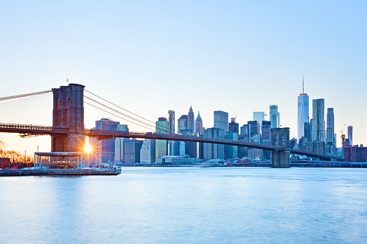 Sunset burst, New York Skyline, Brooklyn Bridge with icy blue tone