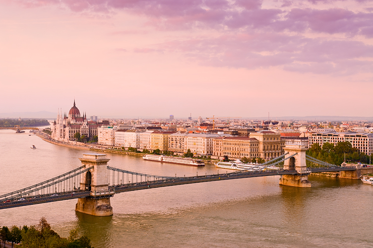 Overview of Budapest with Chain Bridge and Parliament with pink hue sunset