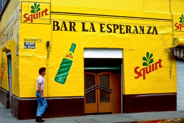 Exterior of colorful yellow building in old neighborhood, Mexico City